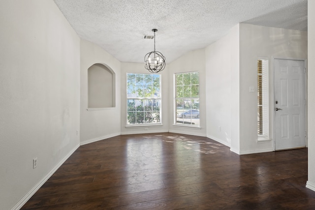 unfurnished room with a textured ceiling, vaulted ceiling, dark hardwood / wood-style floors, and a notable chandelier