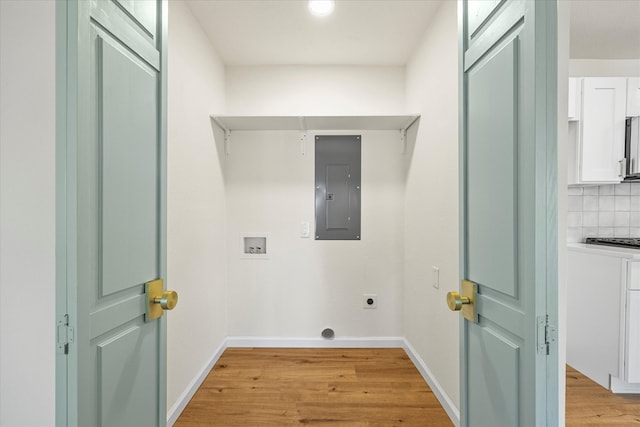 laundry room with electric panel, light hardwood / wood-style flooring, washer hookup, and hookup for an electric dryer