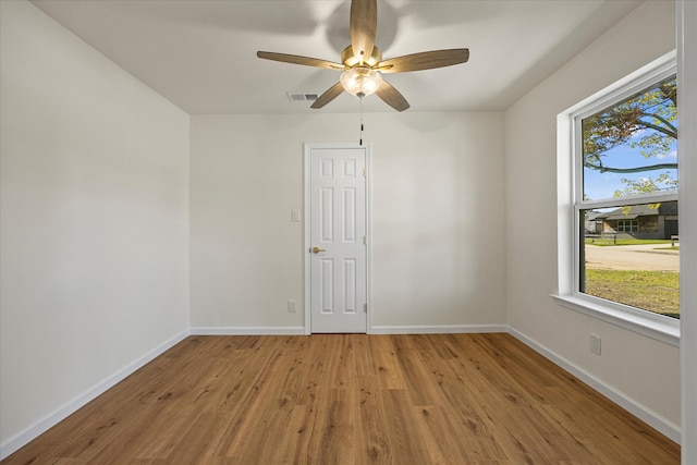 empty room featuring ceiling fan and light hardwood / wood-style flooring