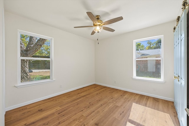 spare room featuring ceiling fan and light hardwood / wood-style floors