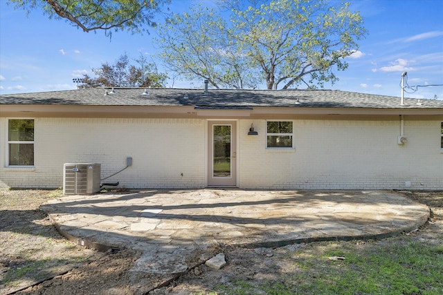 rear view of house with a patio and central AC unit