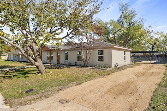 ranch-style house with a carport and a front lawn