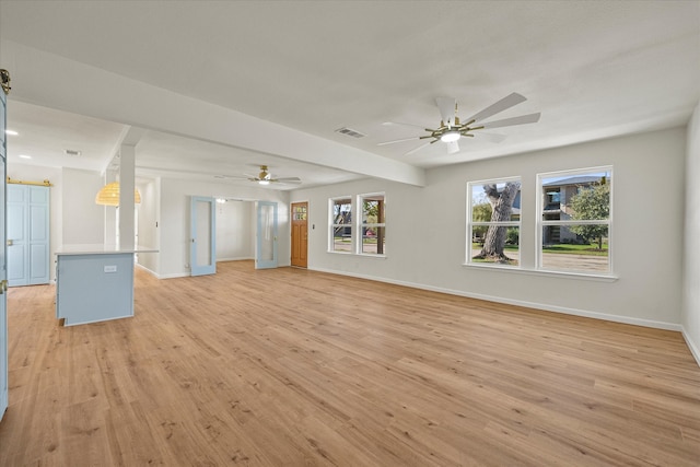 unfurnished living room with ceiling fan and light wood-type flooring