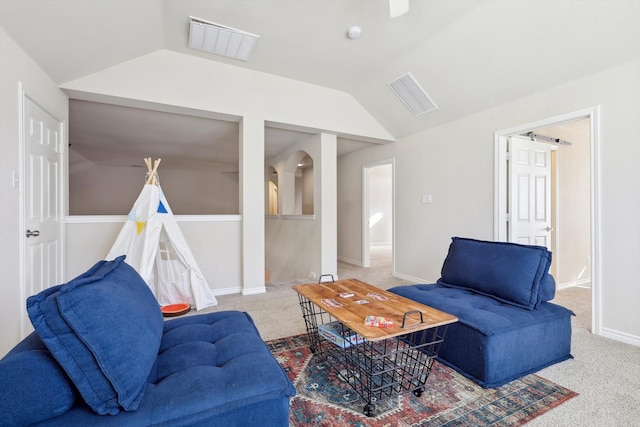 carpeted living room with lofted ceiling