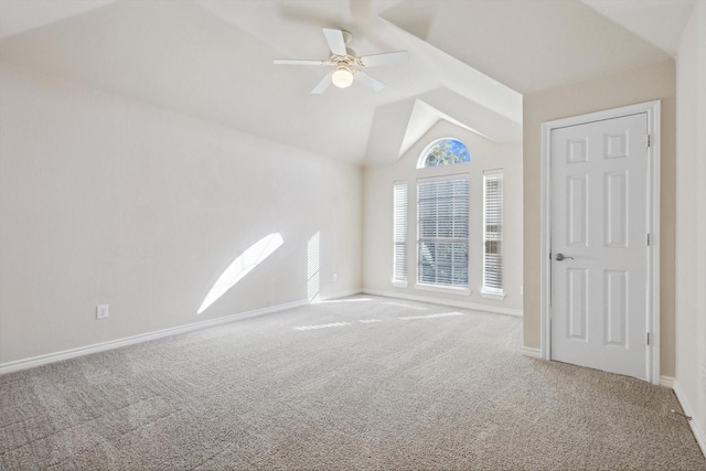 interior space with vaulted ceiling, ceiling fan, and carpet floors