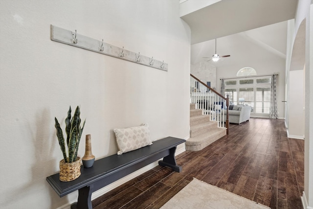 entryway with ceiling fan, dark hardwood / wood-style flooring, and high vaulted ceiling