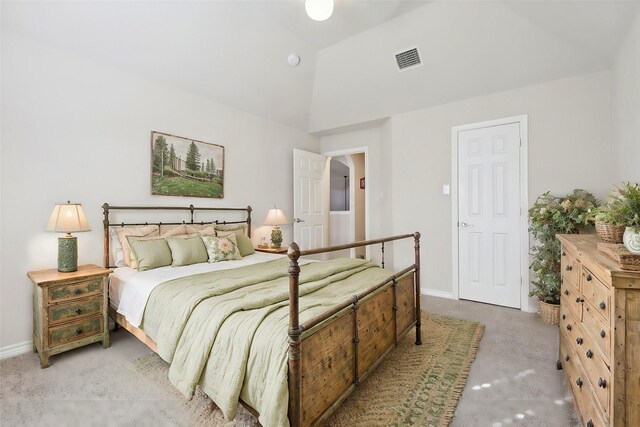 bedroom with carpet flooring and lofted ceiling