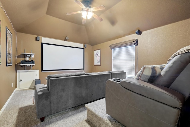 carpeted cinema room with ceiling fan and lofted ceiling