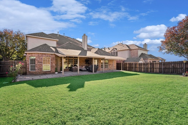 back of house featuring a patio area and a yard