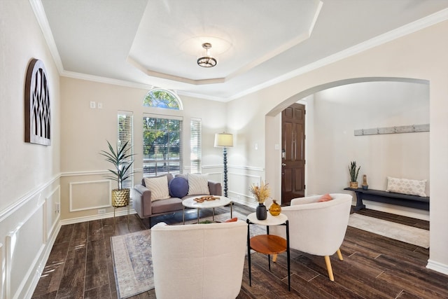 sitting room with dark hardwood / wood-style flooring, ornamental molding, and a tray ceiling