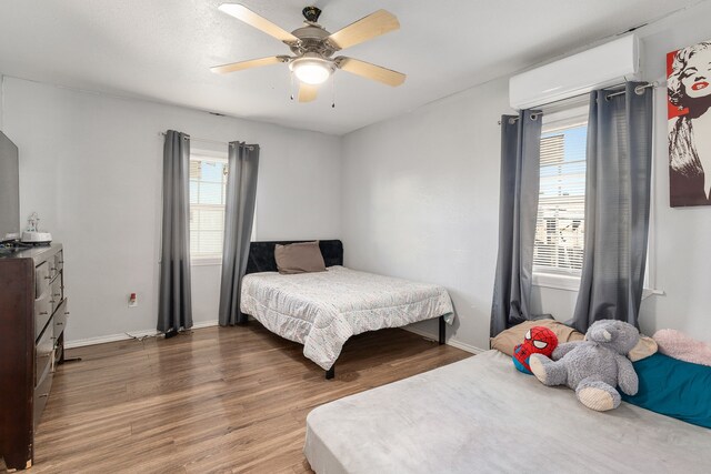 bedroom with ceiling fan and hardwood / wood-style floors