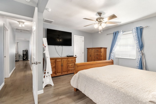 bedroom featuring wood-type flooring, a closet, and ceiling fan