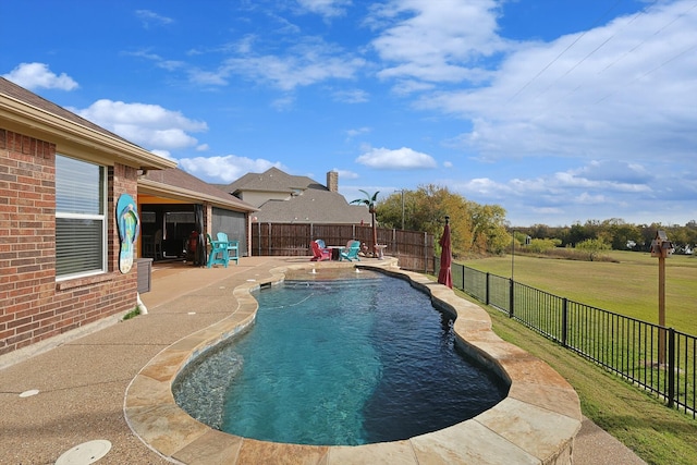 view of swimming pool featuring a lawn and a patio area