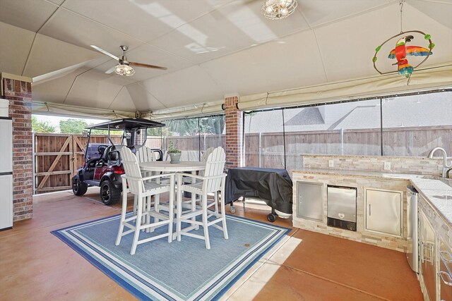 view of patio / terrace with an outdoor kitchen and sink