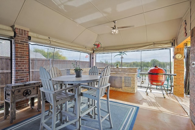 sunroom featuring ceiling fan