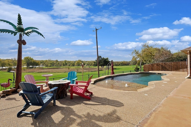 view of swimming pool featuring a yard, a patio, and an outdoor fire pit