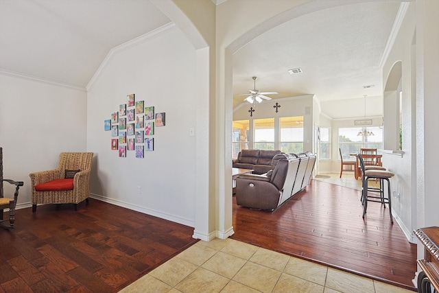 living area with lofted ceiling, light hardwood / wood-style floors, ceiling fan, and crown molding