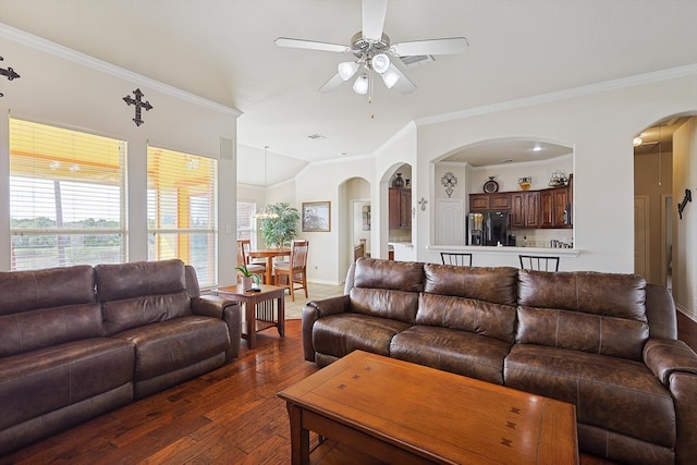 living room with dark hardwood / wood-style floors, ceiling fan, and ornamental molding