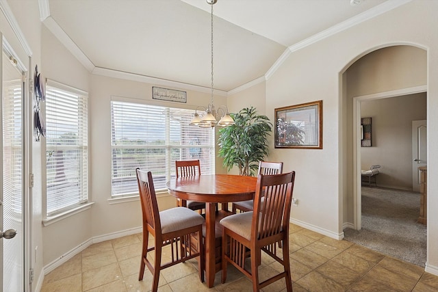 tiled dining area with ornamental molding, a healthy amount of sunlight, lofted ceiling, and a notable chandelier