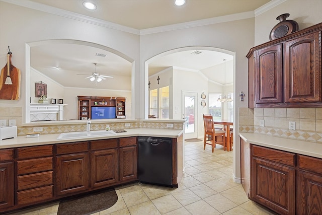 kitchen featuring decorative backsplash, kitchen peninsula, ceiling fan with notable chandelier, sink, and black dishwasher