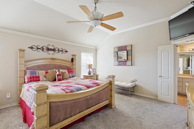 carpeted bedroom featuring ceiling fan, crown molding, ensuite bathroom, and vaulted ceiling