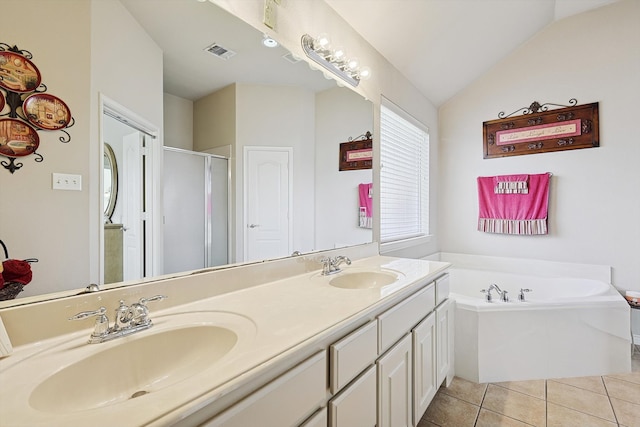 bathroom featuring tile patterned floors, vanity, lofted ceiling, and independent shower and bath