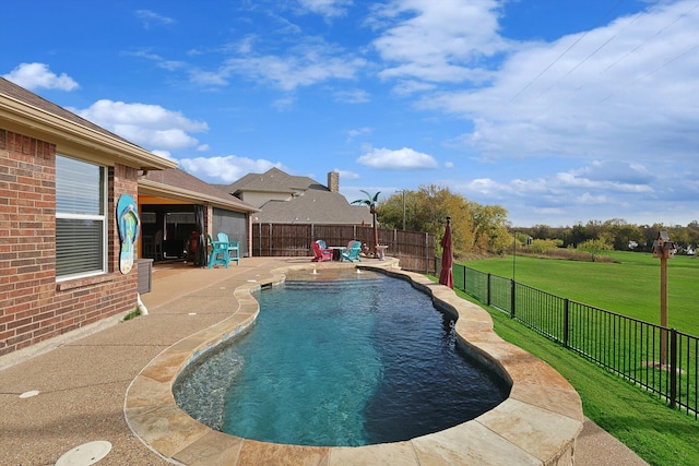 view of swimming pool with a lawn and a patio