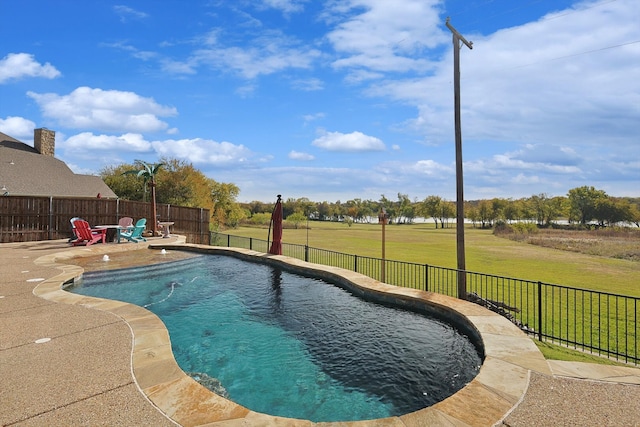 view of swimming pool featuring a yard and a patio area