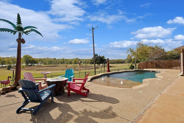 view of swimming pool featuring a fire pit and a patio area