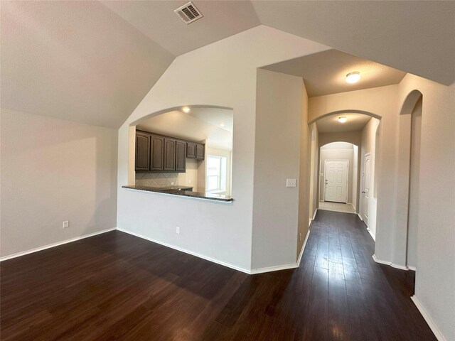 unfurnished living room with dark hardwood / wood-style floors and lofted ceiling