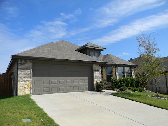 view of front of house featuring a garage and a front yard