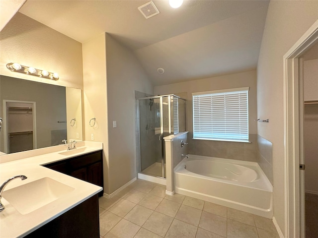 bathroom featuring tile patterned floors, vanity, lofted ceiling, and independent shower and bath