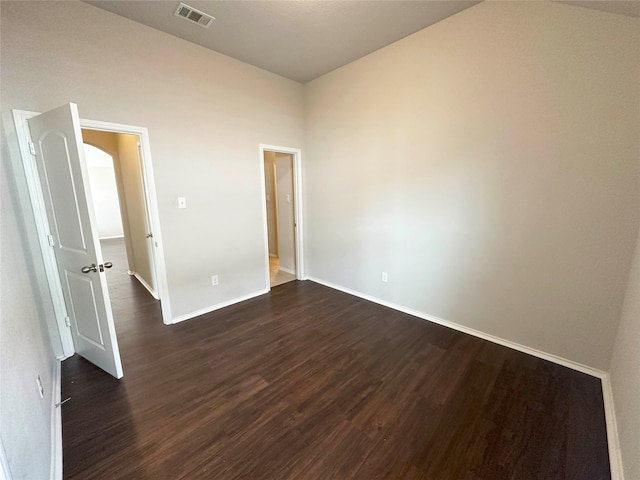 unfurnished room featuring dark hardwood / wood-style floors