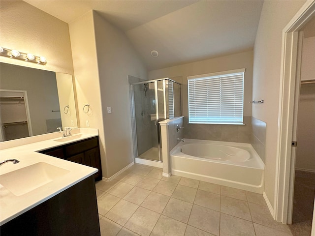 bathroom featuring tile patterned flooring, vanity, vaulted ceiling, and shower with separate bathtub