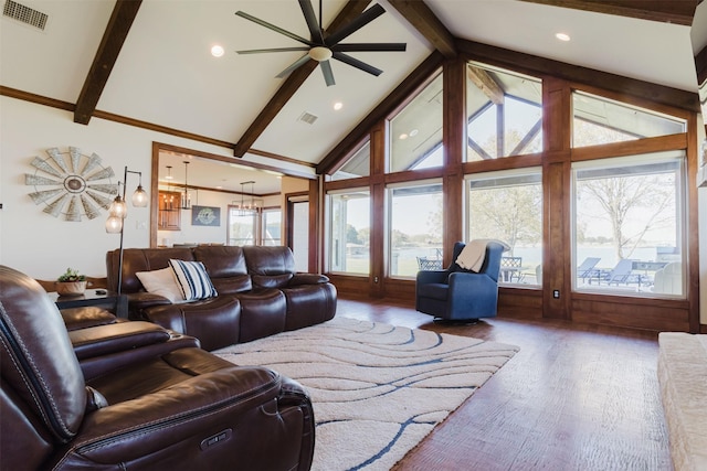 living room with beamed ceiling, ceiling fan with notable chandelier, wood finished floors, and visible vents