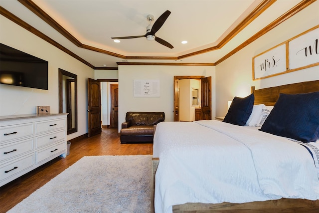 bedroom with recessed lighting, dark wood-style flooring, a ceiling fan, a raised ceiling, and crown molding