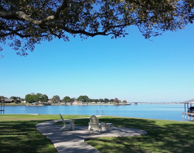 view of property's community featuring a water view and a lawn