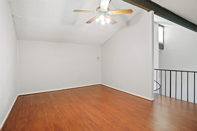 bonus room featuring lofted ceiling with beams, wood-type flooring, and a textured ceiling