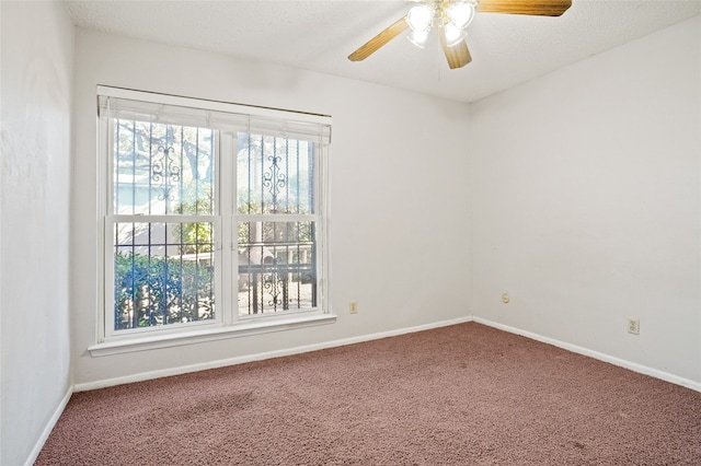 spare room featuring ceiling fan and carpet