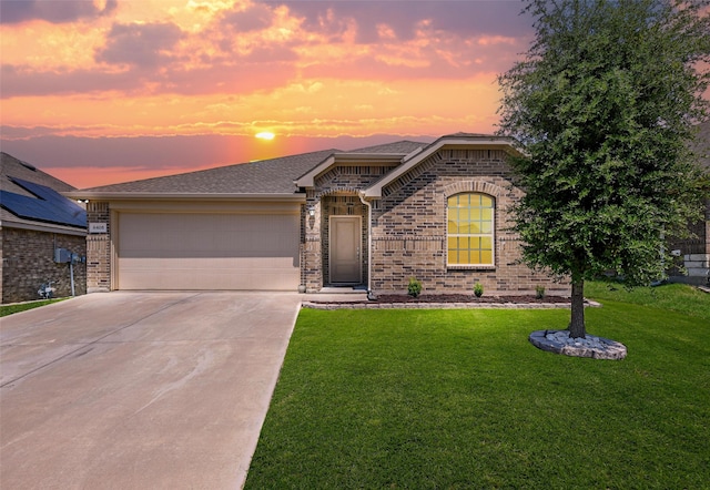 view of front facade with a yard and a garage