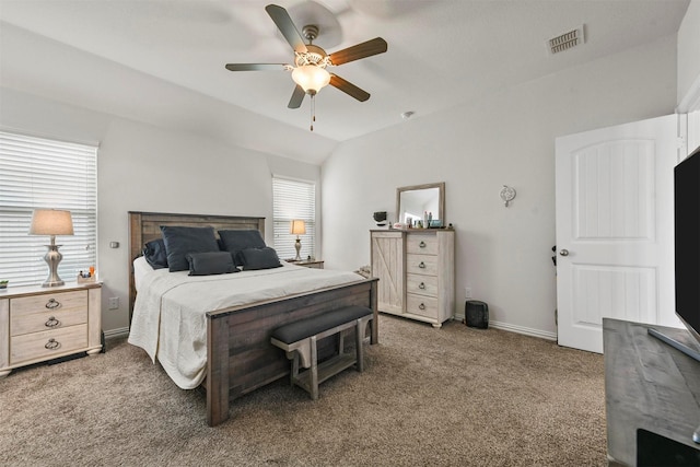 carpeted bedroom featuring visible vents, ceiling fan, baseboards, and vaulted ceiling