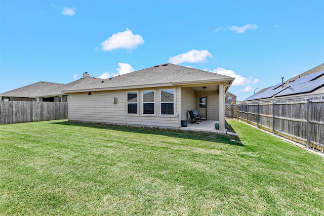 rear view of house featuring a patio area, a fenced backyard, and a yard