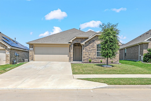 view of front facade featuring a garage, a front lawn, and central air condition unit