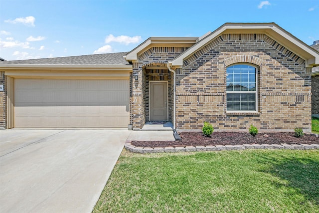 view of front of property featuring a front lawn, roof with shingles, concrete driveway, a garage, and brick siding