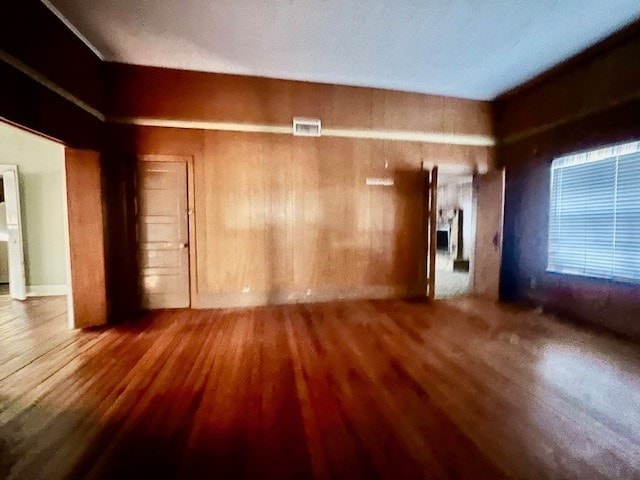 empty room with hardwood / wood-style flooring