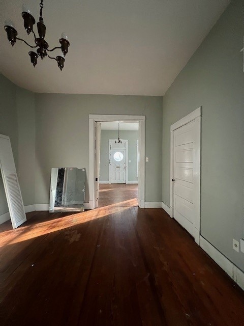 foyer with hardwood / wood-style floors and an inviting chandelier