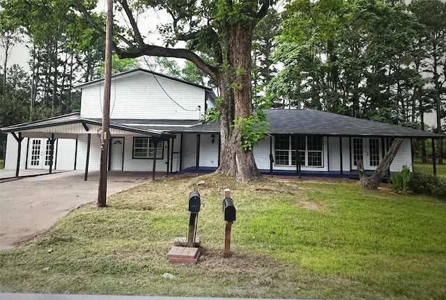 view of front of property with a front lawn and a carport