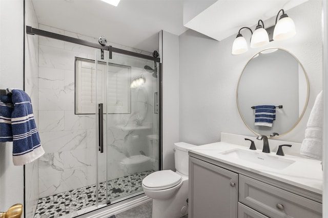 bathroom with vanity, an enclosed shower, and toilet