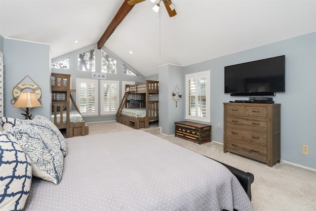 carpeted bedroom featuring multiple windows, vaulted ceiling with beams, and ceiling fan