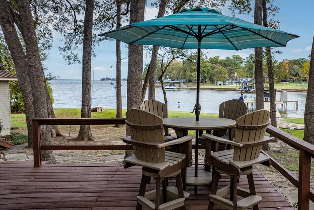 wooden terrace featuring a water view